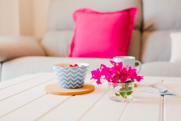 Fleurs sur la table avec petit déjeuner servi