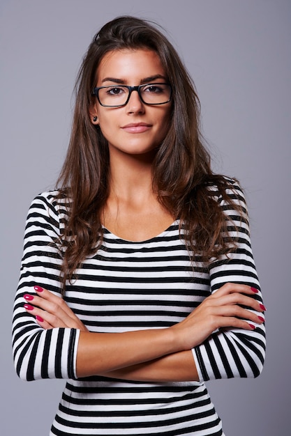 Fond gris et femme avec des lunettes noires