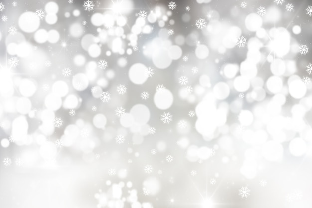 Fond de Noël avec des flocons de neige et des lumières bokeh