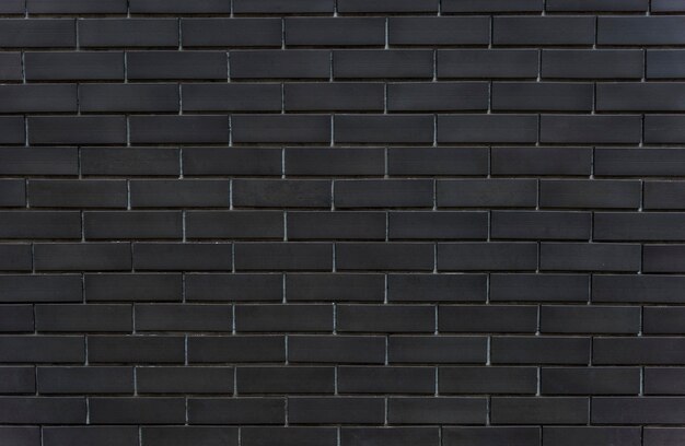 Fond texturé de mur de briques noires