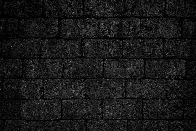 Fond de texture de mur de briques rugueuses noires.