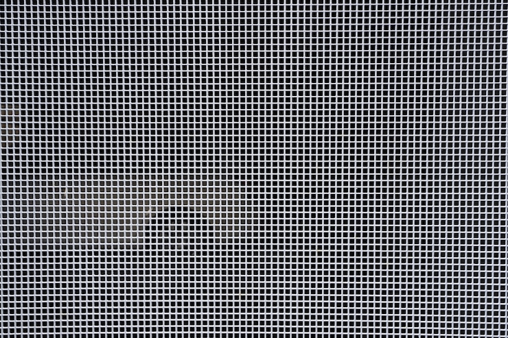 Photo gratuit fond avec treillis métallique et trous ronds