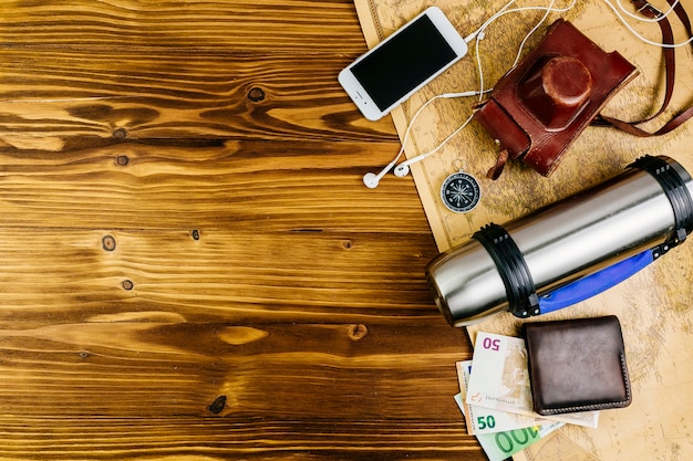 Fond de voyage en bois avec accessoires et copyspace sur la gauche