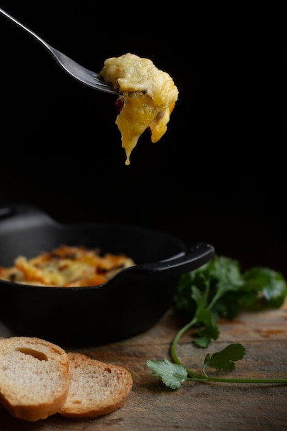 Fourchette avec fromage fondu et pain grillé