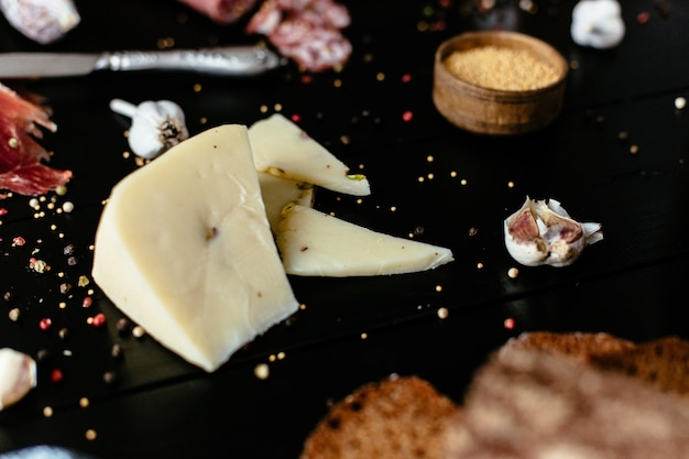 Fromage délicieux avec festashkami sur une table en bois noire