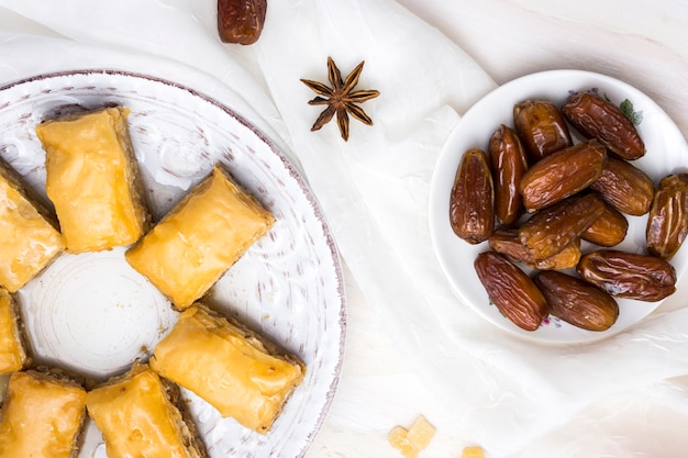 Fruit de dattes séchées avec des bonbons orientaux sur une table blanche