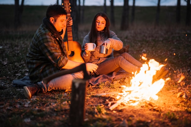 Full shot couple holding guitar