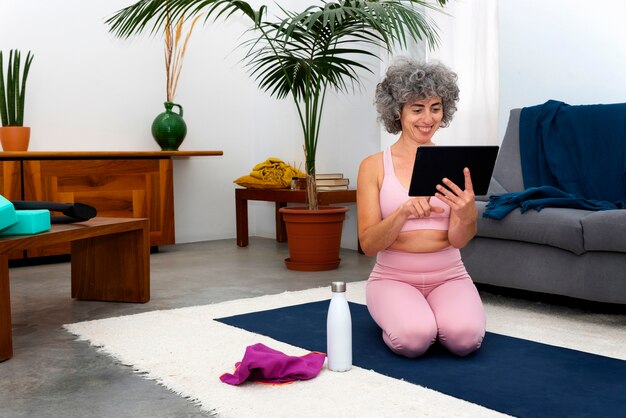 Full shot woman holding tablet