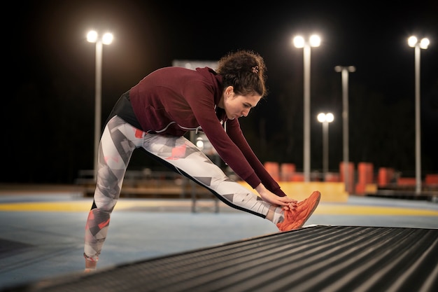 Full shot woman stretching lacets