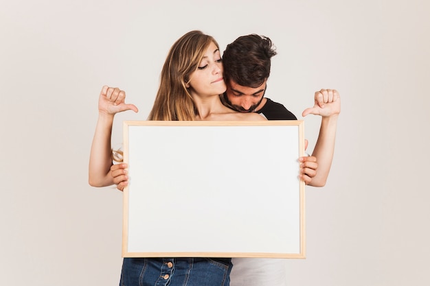 Funny couple holding board