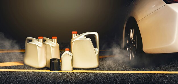 Un gallon d'or de lubrifiant et un filtre à huile de voiture ont été placés sur la route asphaltée avec de la fumée