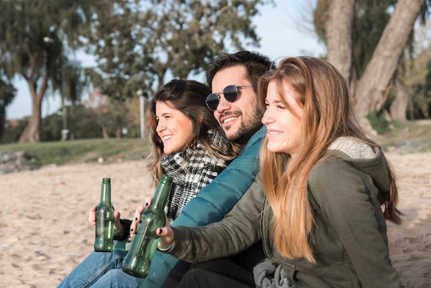 Photo gratuite gens buvant de la bière au bord de la mer