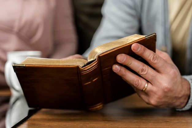 Gens dans la cuisine lisant la Bible