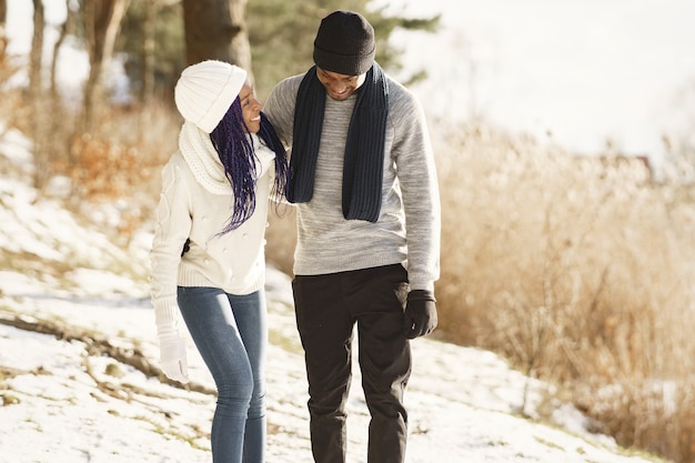 Les gens marchent dehors. Jour d'hiver. Couple africain