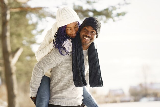 Les gens marchent dehors. Jour d'hiver. Couple africain