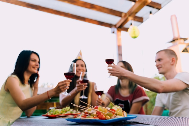 Gens portant un verre de vin à la fête