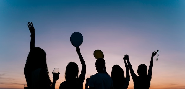 Gens qui dansent à la fête sur le toit à l'aube