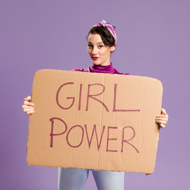 Girl power lettrage sur carton et femme plan moyen