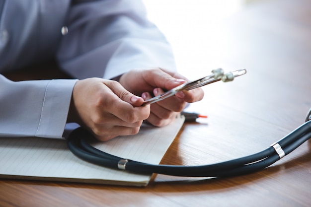 Grand plan, de, médecins, mains, à, stéthoscope, feuilles, et, pilules, sur, fond bois