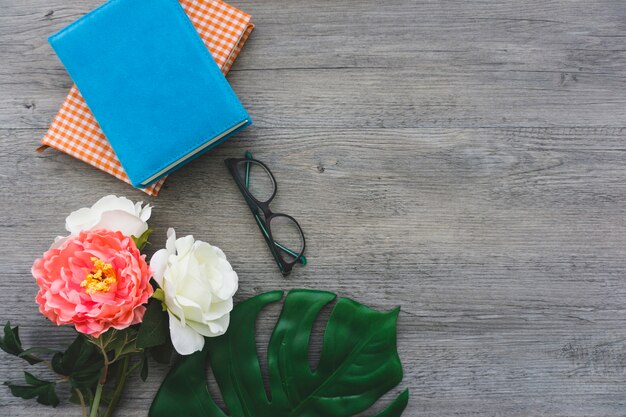 Grande composition avec des fleurs, des lunettes et des livres