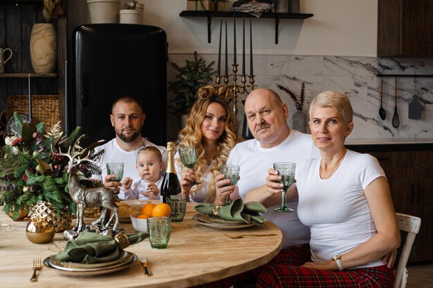 La grande famille prend le petit-déjeuner de noël ensemble dans la cuisine