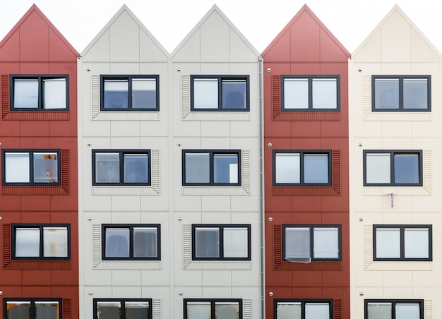 Gros plan d'un bâtiment avec des sections rouges et blanches et des toits triangulaires