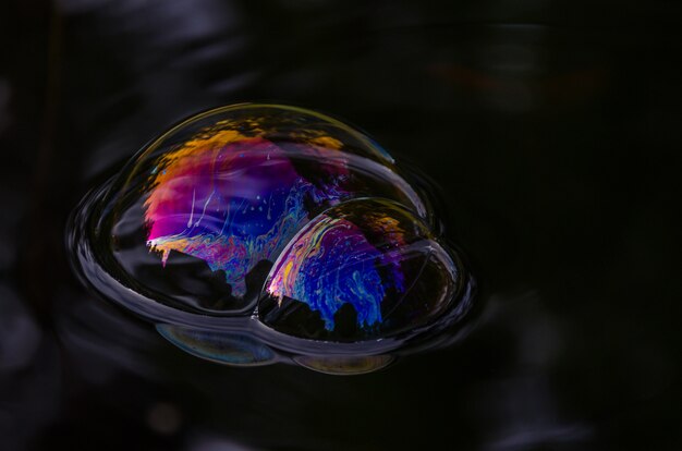 Photo gratuite gros plan d'une bulle colorée sur une eau