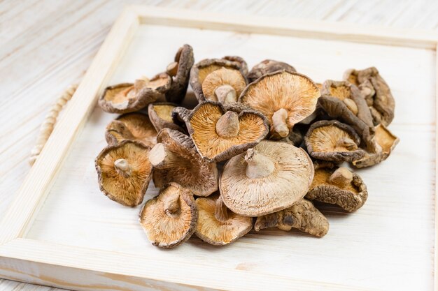 Gros plan de champignons shiitake séchés sur fond de bois