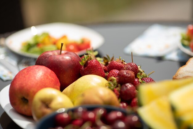 Gros plan de délicieuses cerises rouges debout sur une plaque sur la table