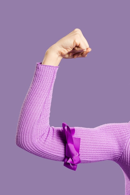 Photo gratuite gros plan du bras musculaire attaché avec un ruban violet