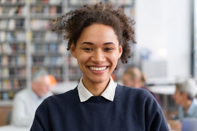 Gros plan femme souriante dans la bibliothèque