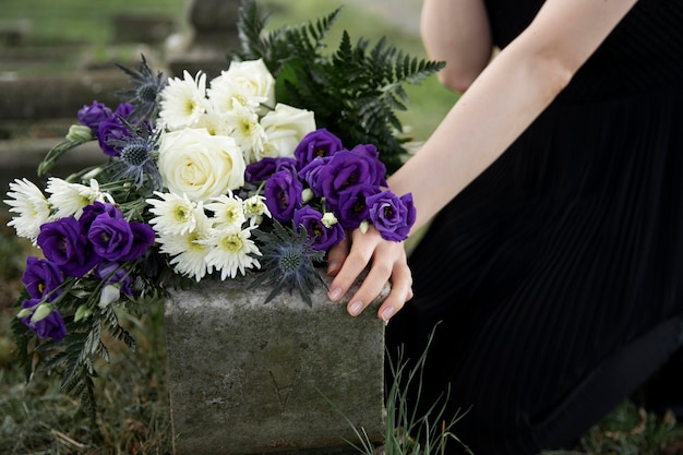 Gros plan sur une femme visitant la tombe d'un être cher