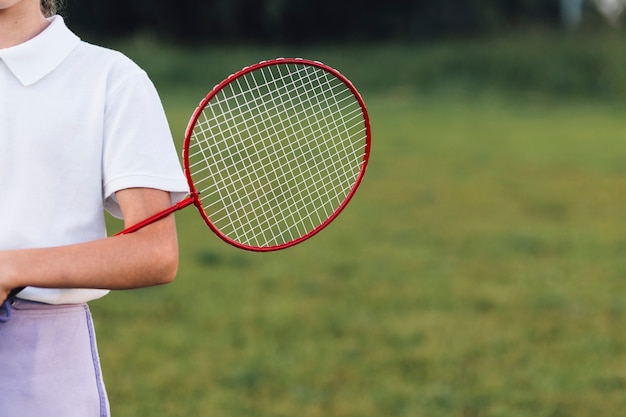 Gros plan, fille, tenue, badminton, dans parc