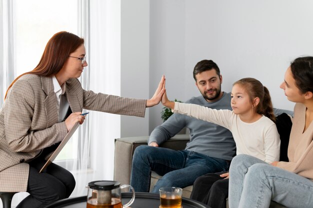 Gros plan fille et thérapeute high five