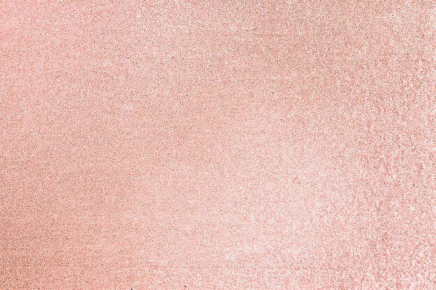 Gros plan sur fond texturé de paillettes rose blush