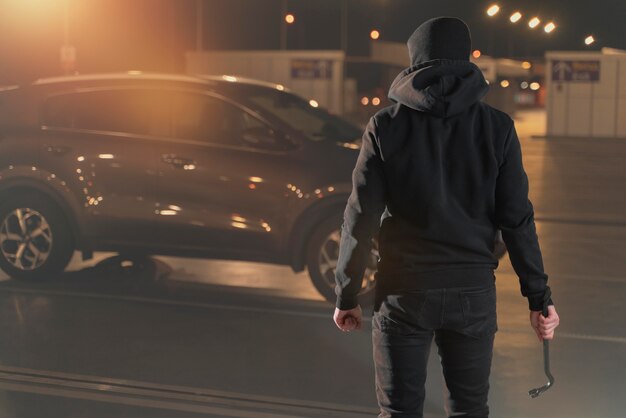 Gros plan sur un homme essayant de s'introduire dans une voiture