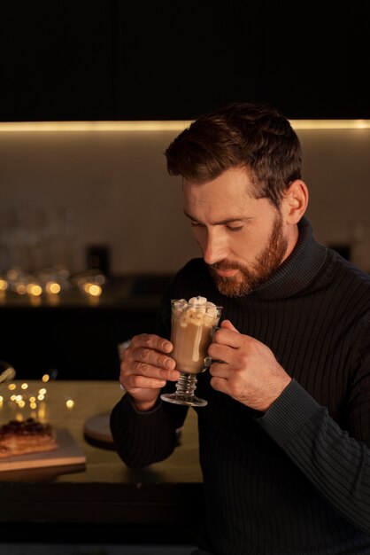 Gros plan sur un jeune adulte appréciant une boisson chaude