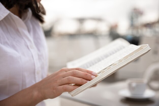 Gros plan d'un livre entre les mains des femmes