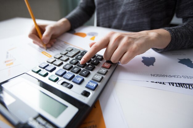 Gros plan, main, femme, comptage, calculatrice