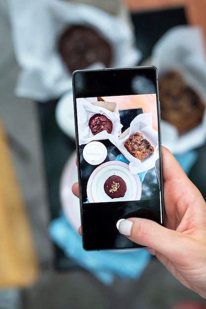 Gros plan main tenant des photos de desserts