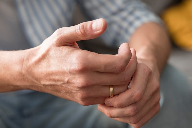 Gros plan des mains portant une bague de mariage