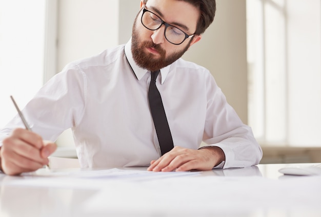 Gros plan, mâle, mains avec un stylo sur le document