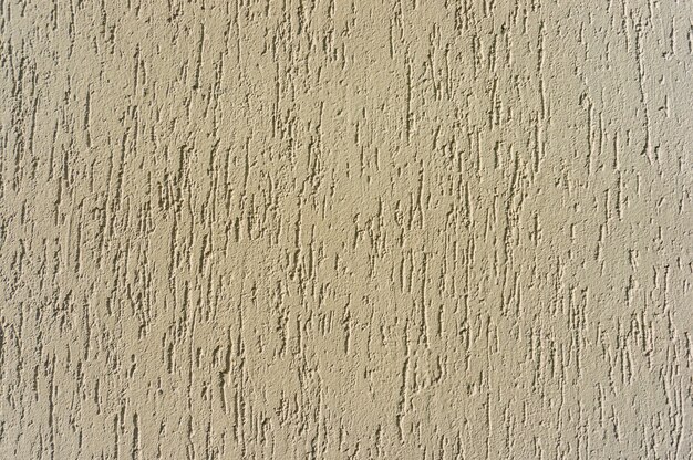 Gros plan d'un mur texturé beige