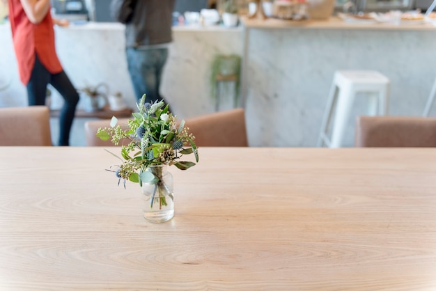 Gros plan de la nature laisse dans un vase sur une table en bois