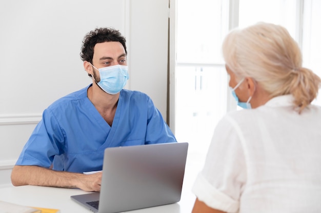 Gros plan sur pacient parlant au médecin au sujet du vaccin