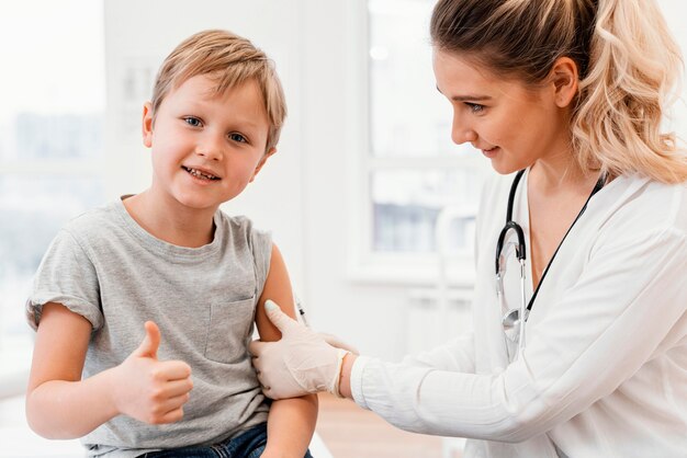 Gros plan pédiatre enfant vaccinant