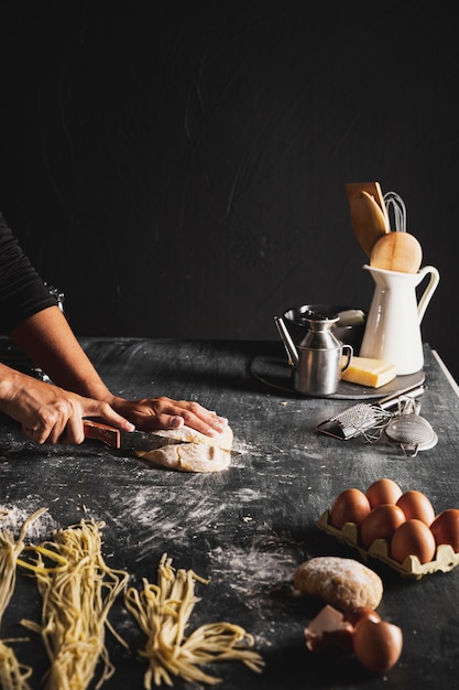 Gros plan personne couper la pâte avec des ustensiles