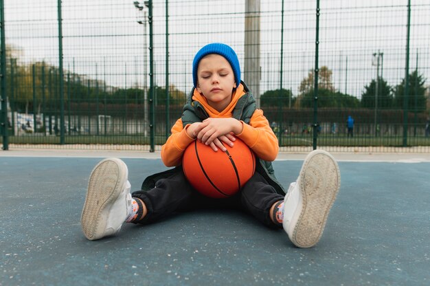 Gros plan sur un petit garçon jouant au basket