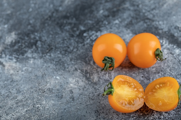 Gros plan photo de tomates jaunes coupées à moitié ou entières. Photo de haute qualité