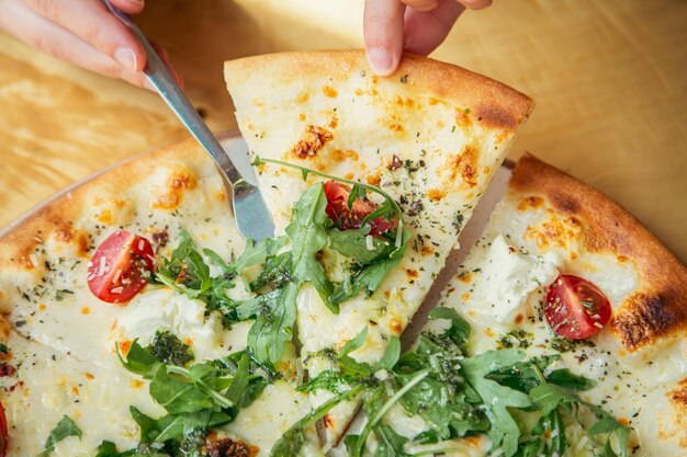 Gros plan de pizza végétarienne aux légumes sur une vue de dessus de table en bois